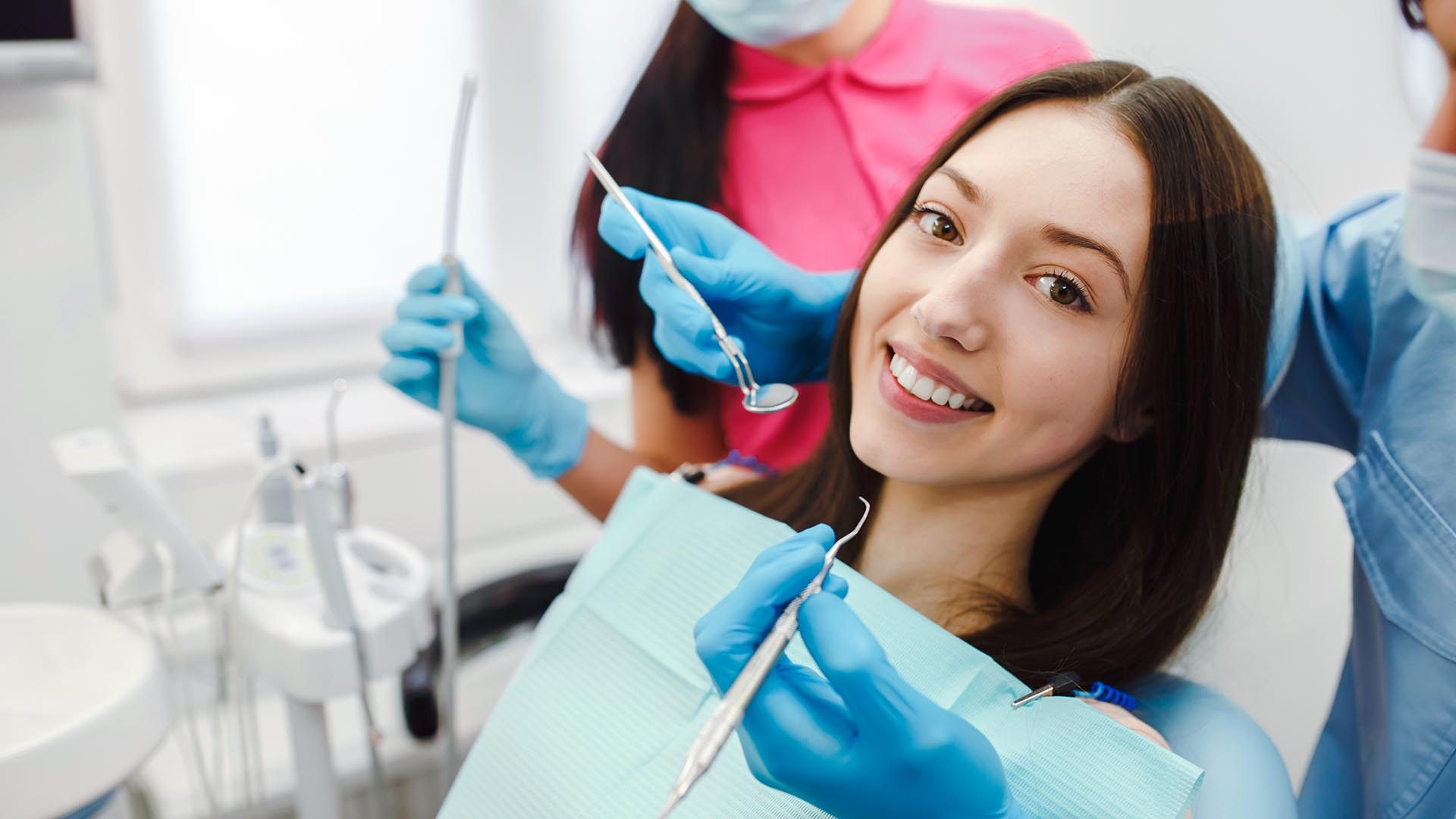 smiling woman dentist chair e1724331277987